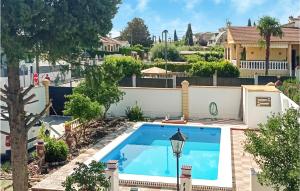 a swimming pool in the backyard of a house at Nice Home In El Ventorrillo With Outdoor Swimming Pool, Wifi And Private Swimming Pool in Belicena