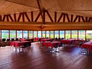 a large room with tables and chairs and windows at Kayak Camp, Tsonjinboldog in Narst