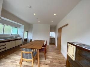 eine Küche und ein Esszimmer mit einem Holztisch und Stühlen in der Unterkunft Ayu House - Vacation STAY 03971v in Nagahama