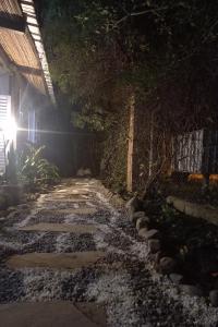 a stone walkway in a garden at night at imanalla in Salta