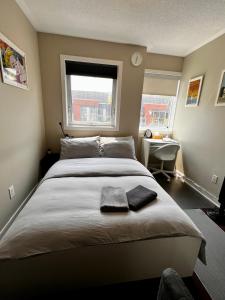 a bedroom with a large bed with two towels on it at Home in Downtown in Toronto