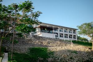 a building with a lot of rocks in front of it at Wangpruksa Resort in Ban Nong Bua