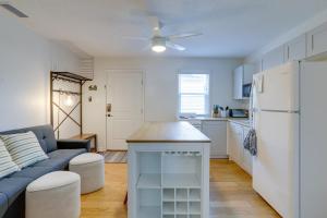 a kitchen and living room with a couch and a refrigerator at St Petersburg Vacation Rental 1 Mi to Downtown! in St Petersburg