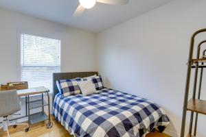 a bedroom with a bed and a desk and a window at St Petersburg Vacation Rental 1 Mi to Downtown! in St. Petersburg