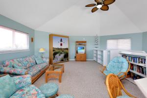 a living room with a couch and chairs and a tv at DeLight House by Pristine Properties Vacation Rentals in Indian Pass