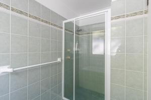 a shower with a glass door in a bathroom at Peaceful Cul de sac in Sussex inlet +15 photos