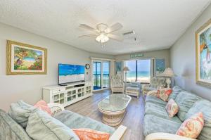 a living room with a couch and a tv at Anna Maria Island Beach Sands 201 in Bradenton Beach