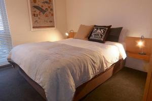a bedroom with a large bed with a pillow on it at Twin Towers 102a in Mount Buller