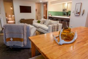 a living room with a couch and a table at Twin Towers 102a in Mount Buller
