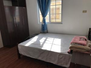 a bedroom with a large bed with a window at RPU WEN`S Villa in Dauis