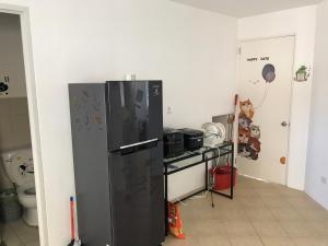 a kitchen with a black refrigerator and a counter at RPU WEN`S Villa in Dauis