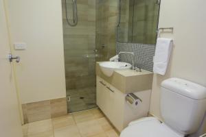 a bathroom with a toilet and a sink and a shower at Alto Villa 301 in Mount Buller