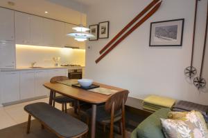 a kitchen and dining room with a table and chairs at Alto Villa 403 in Mount Buller