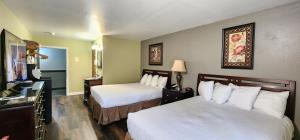 a hotel room with two beds and a television at Crest Trail Lodge in Packwood