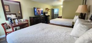 a hotel room with two beds and a mirror at Crest Trail Lodge in Packwood