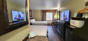 a hotel room with a bed and a tv at Crest Trail Lodge in Packwood