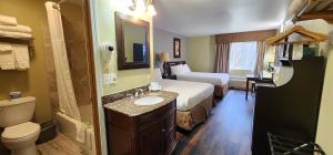 a hotel room with a bed and a bathroom at Crest Trail Lodge in Packwood