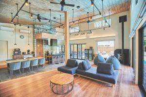 a living room with a couch and a table at Villa Saison Fuji ヴィラ セゾン フジ in Fujikawaguchiko