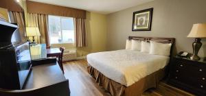 a hotel room with a bed and a desk at Crest Trail Lodge in Packwood