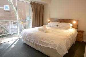 a bedroom with a bed and a large window at Elkhorn 12 in Mount Buller