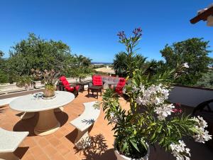 un patio con mesa, sillas y plantas en Villa Lagos Algarve for families & friends, 6 bedrooms, 7 bathrooms, pool, BBQ, central heating en Pedra Alçada