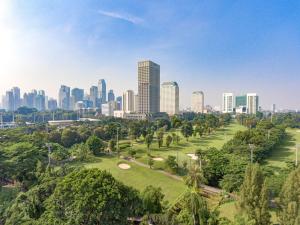 a park with a city skyline in the background at Fairmont Jakarta in Jakarta