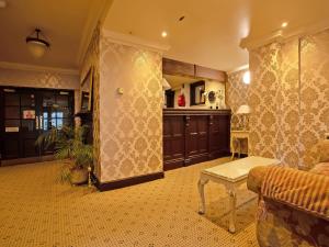 a living room with a couch and a table at Great White Horse Hotel in Ipswich