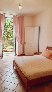 a bedroom with a bed and a large window at La Casa di Christina in Imperia