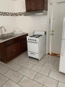 a kitchen with a stove and a sink at Shore Beach Houses - 38 Dupont Avenue in Seaside Heights