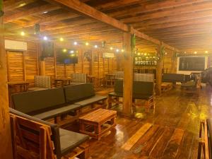 - un salon avec un canapé, des chaises et des tables dans l'établissement Hostal Tropicoco, à Playas