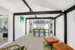 a living room with a table and chairs at Spindrift Unit 1 10 Spectrum Street Rainbow Beach in Rainbow Beach