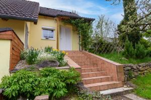 a house with a staircase leading to the front door at Apartmánový dům Vilémovice in Vilémovice