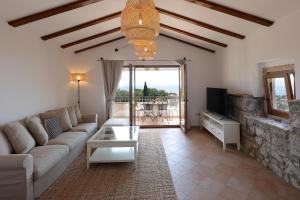 a living room with a couch and a table at Villa Fani with Jacuzzi in Ičići