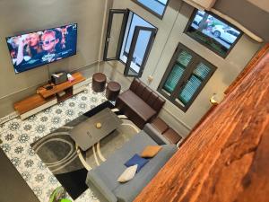 an overhead view of a living room with a couch and a tv at Boulevard Rollandes house in Hanoi