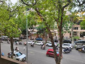 a group of motorcyclists riding down a busy city street at Boulevard Rollandes house in Hanoi +8 photos