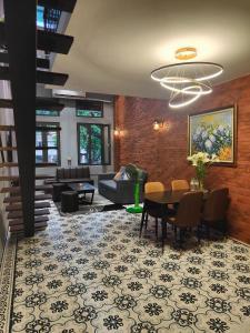 a living room with a couch and a table at Boulevard Rollandes house in Hanoi