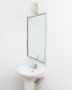a bathroom with a sink and a mirror at Casa Carmen in Santiago Este