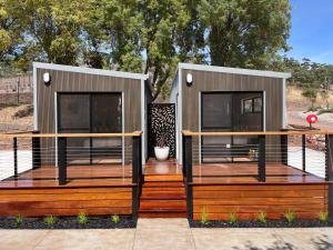 a tiny house with two large windows on a deck at BIG4 Kryal Castle Holiday Park in Leigh Creek