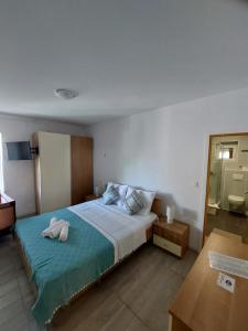 a bedroom with a bed with two towels on it at Apartments Vucetic in Hvar