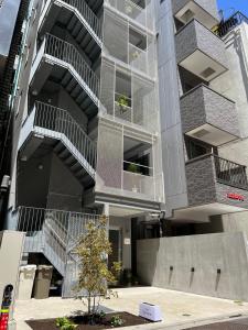 an apartment building with balconies on the side of it at Hotel Apreton in Tokyo