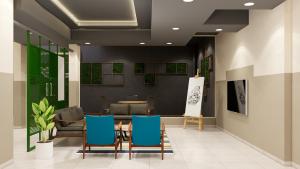 a lobby with chairs and a table and a couch at Covie Gurugram 70 in Gurgaon