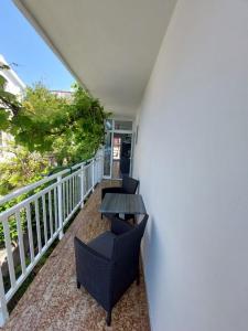 a balcony with two chairs and a table at Apartments Vucetic in Hvar