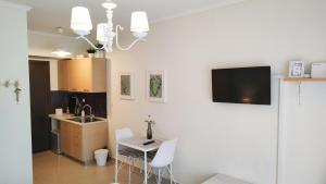 a kitchen with a sink and a table with chairs at City Center Fresh Studio #Self Check In# in Thessaloniki