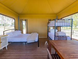a room with two bunk beds and a table at NRMA Lake Somerset Holiday Park in Kilcoy