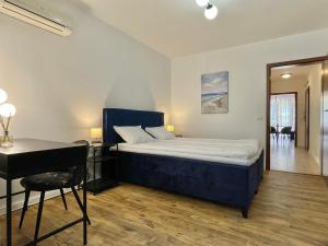 a bedroom with a bed and a desk and a table at Lighthouse - Private apartment - BSR in Sveti Vlas