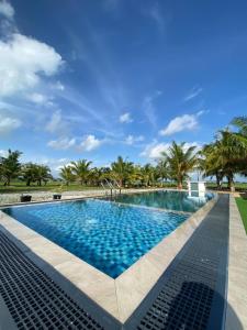 a swimming pool in a resort with trees in the background at Kuala Kedah Pool Cottage in Kuala Kedah