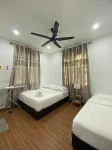 A bed or beds in a room at Kuala Kedah Pool Cottage