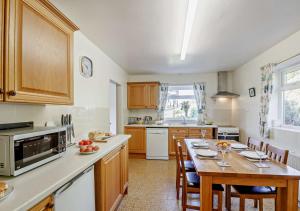 a kitchen with a table and a counter top at Llys Pennant in Gwytherin