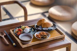 a tray with two plates of food on a table at H& Jiufen The Dragon Inn in Jiufen