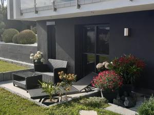 a house with a black door and some plants at 4-Sterne Ferienwohnung Krill in Bad Wurzach